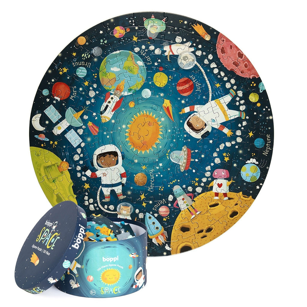 Ronde ruimte-puzzel voor kinderen met bijhorende opbergdoos, kleurrijke illustratie van het zonnestelsel en astronauten.