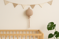 Zand hydrofiele ballon wanddecoratie van katoen boven babybed – minimalistische babykamer